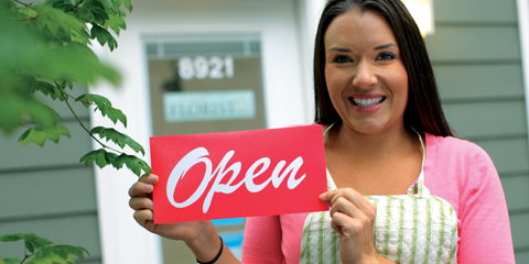 Woman holding Open sign